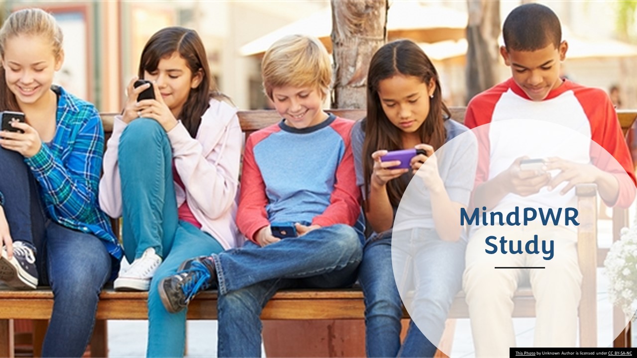 Group of teens with smartphones sitting on a bench