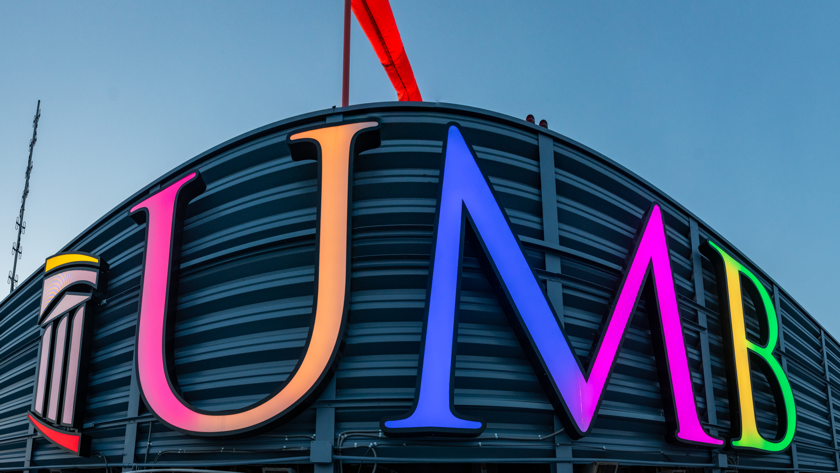 UMB letters illuminated in rainbow 
