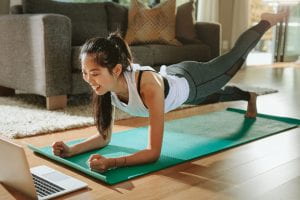 woman doing plank on yoga mat