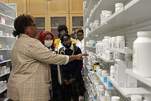 Students from Mother Mary Lange Catholic School look at a shelf of medications.