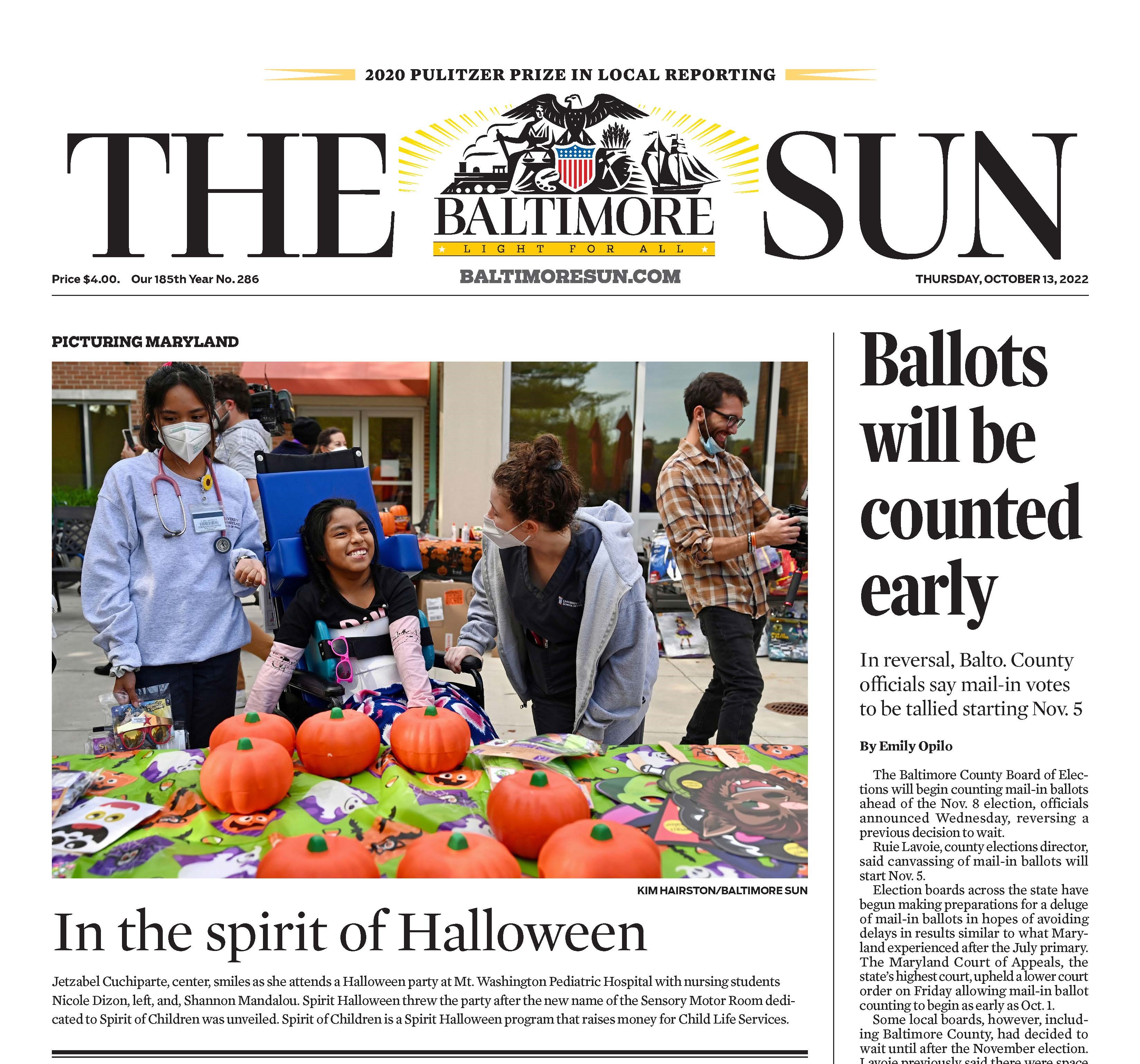 capture of front page of Baltimore Sun; photo of two nursing students with young patient in wheelchair, along with plastic pumpkins and decorations
