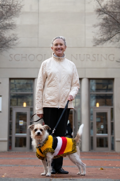 Dean Kirschlng with Frankie on leash in front of UMSON building