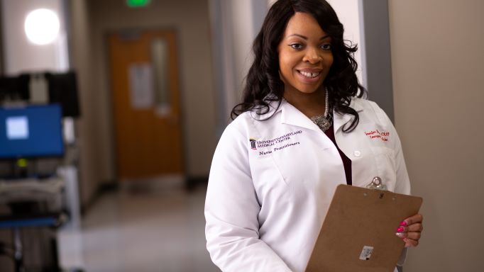 nurse in white coat holding clipboard