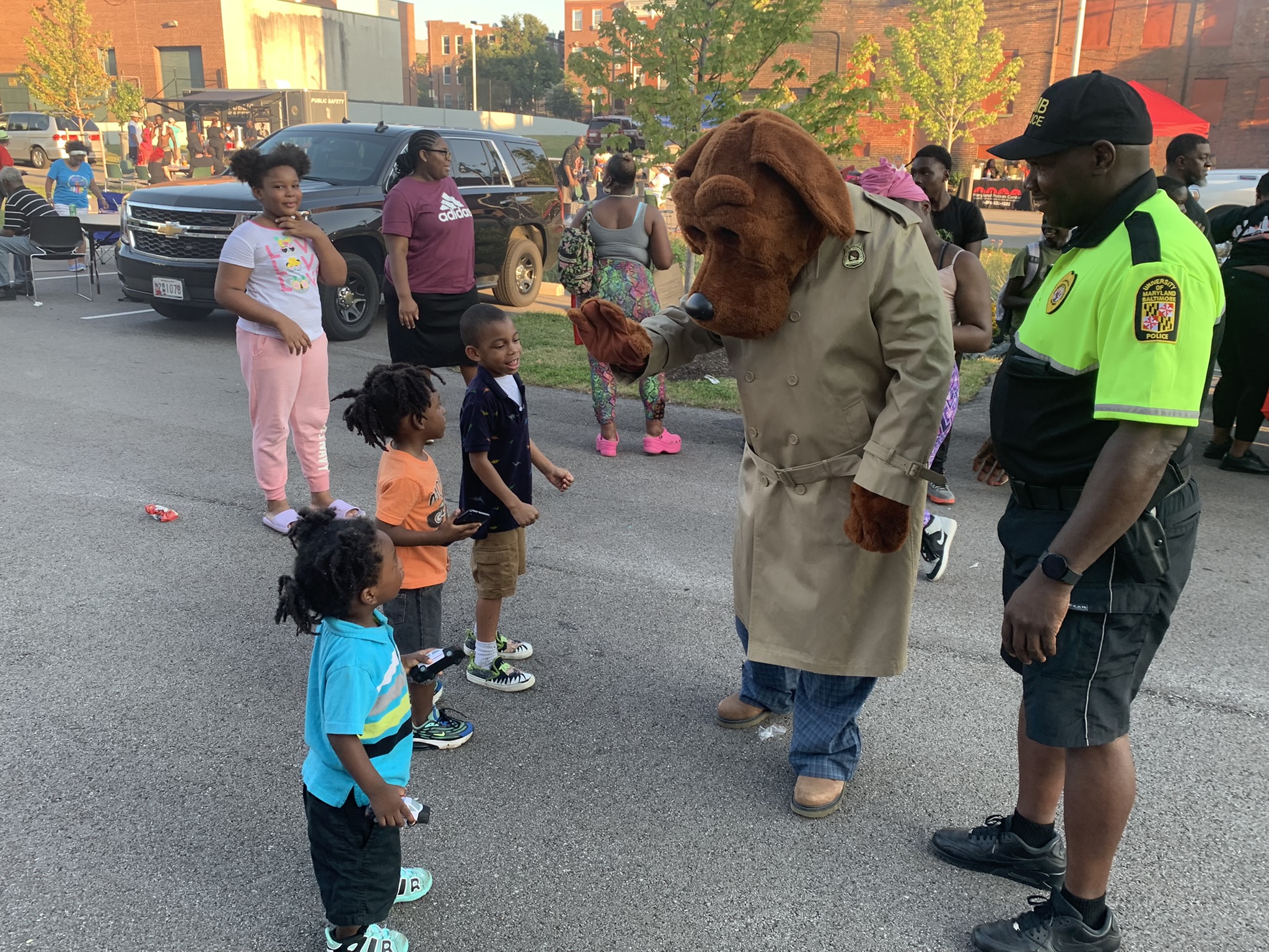 McGruff the Crime Dog high-fives community children at National Night Out