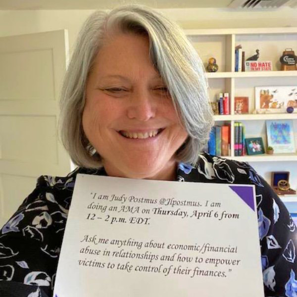 University of Maryland School of Social Work Dean Judy Postmus holding a sign detailing her Reddit Ask Me Anything