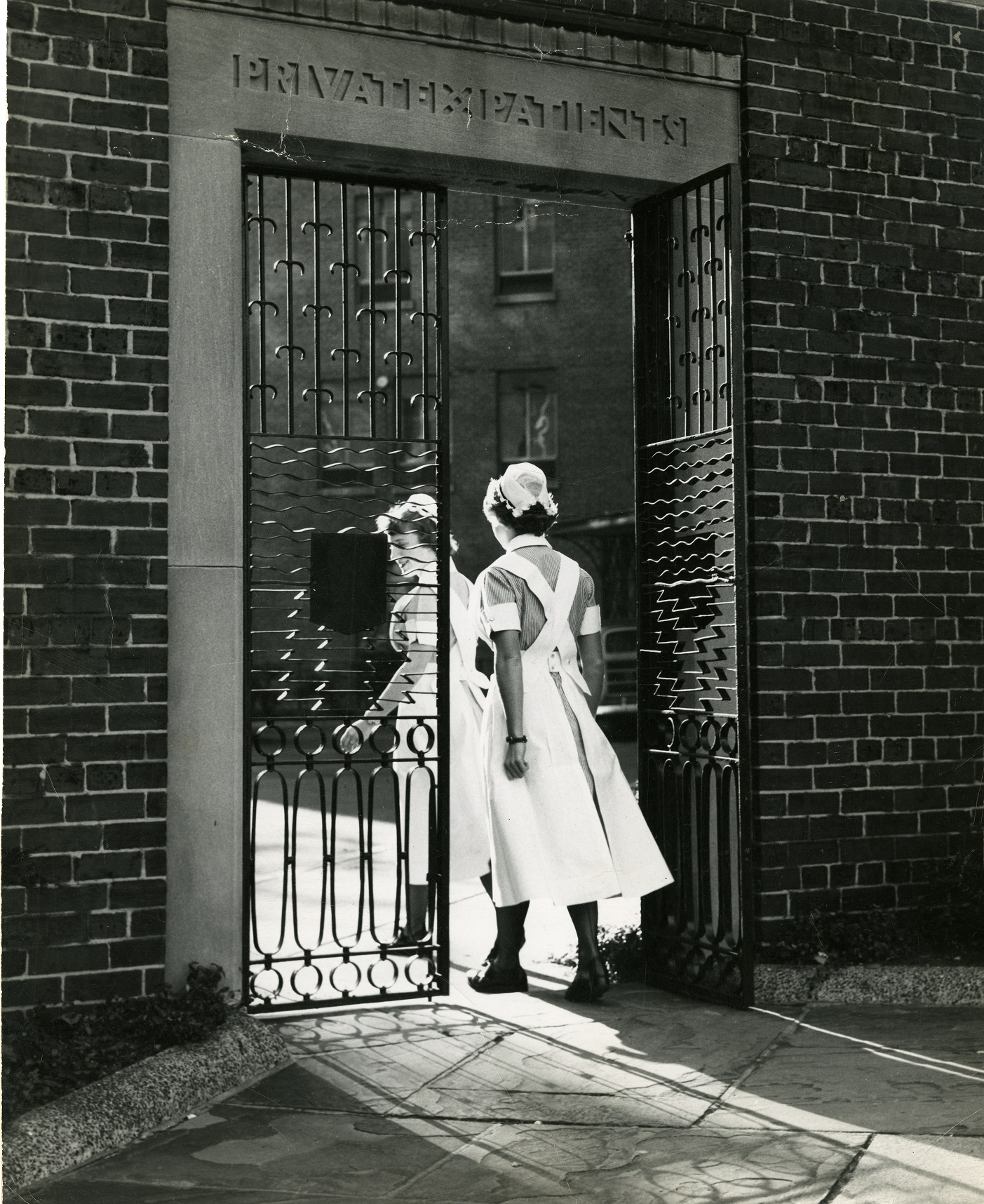 Nursing students entering private patients gates ca 1940s