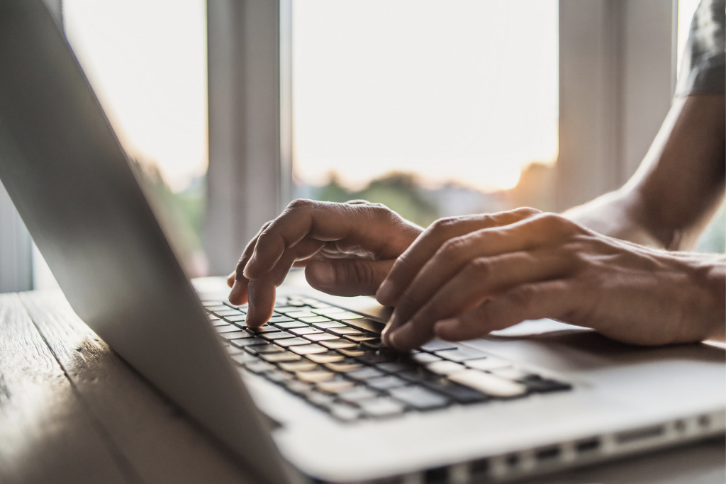 hands typing on keyboard