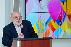 Raymond Love smiles while speaking at his retirement party.
