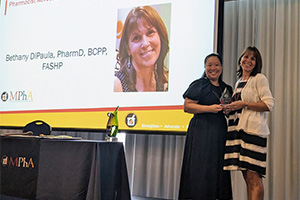 Bethany DiPaula receives an award at the MPhA annual convention from Deanna Tran.
