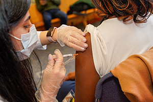 A student pharmacist provides a vaccine to a patient.