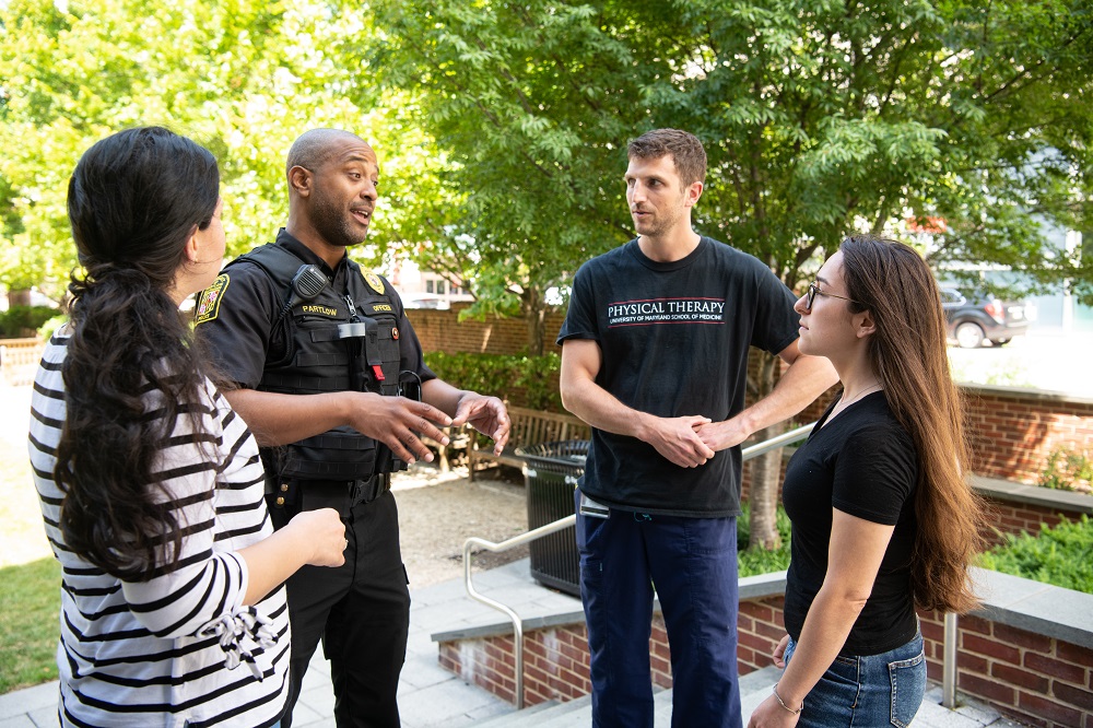 Cpl. Yale Partlow talking with students