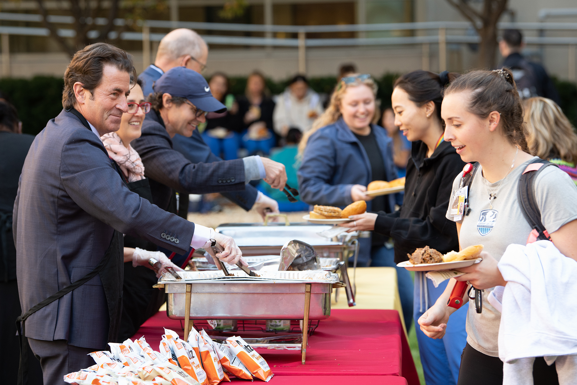 Deans and VPs serve students at the cookout