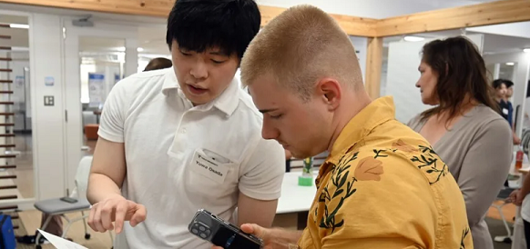 UMB student works with a student from Japan.