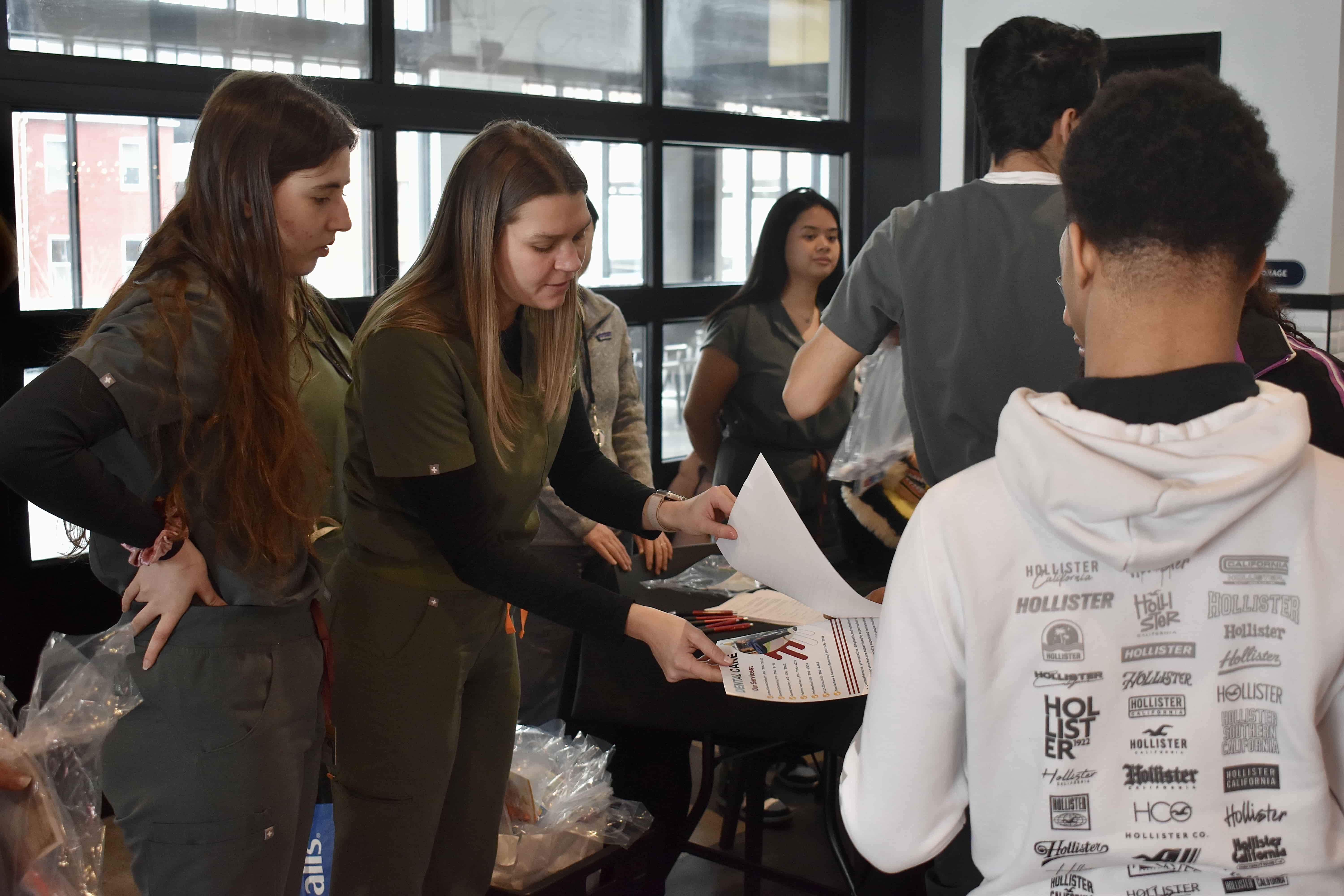 dental students handing out information at tables 