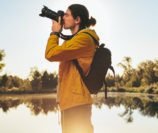 A man takes a photo outside