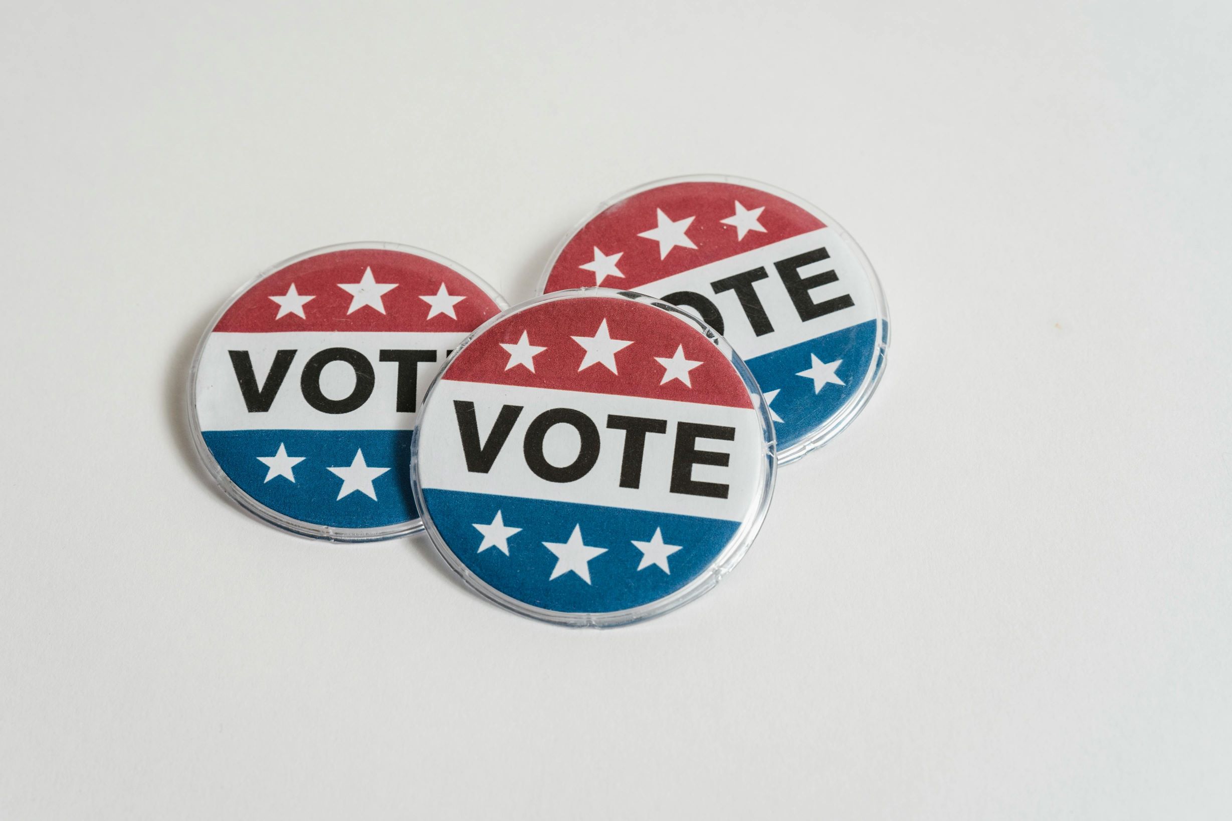 Red, white and blue push pin with VOTE in black letters