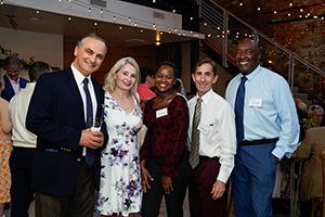 Five members of the David Stewart Associates Society smile for a photo.