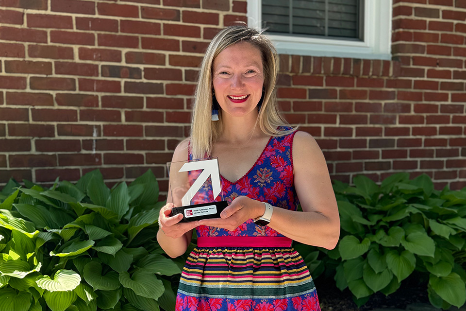 Lauren Hynicka holds the Pathfinder Award.