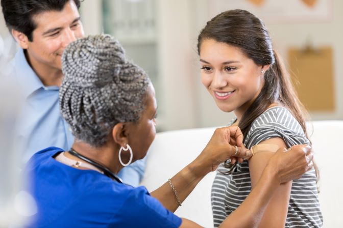 nurse giving woman a shot