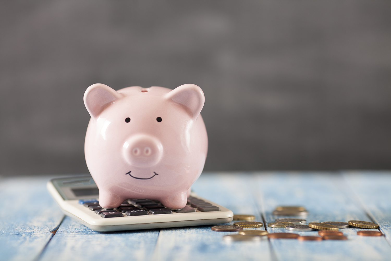 piggy bank sitting on a pile of money