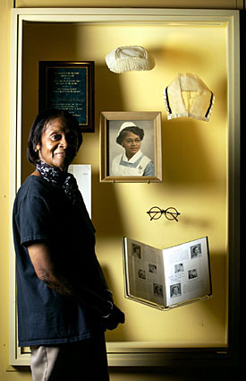 Esther McCready standing in front of an exhibit case at the Reginald F. Lewis Museum in Baltimore