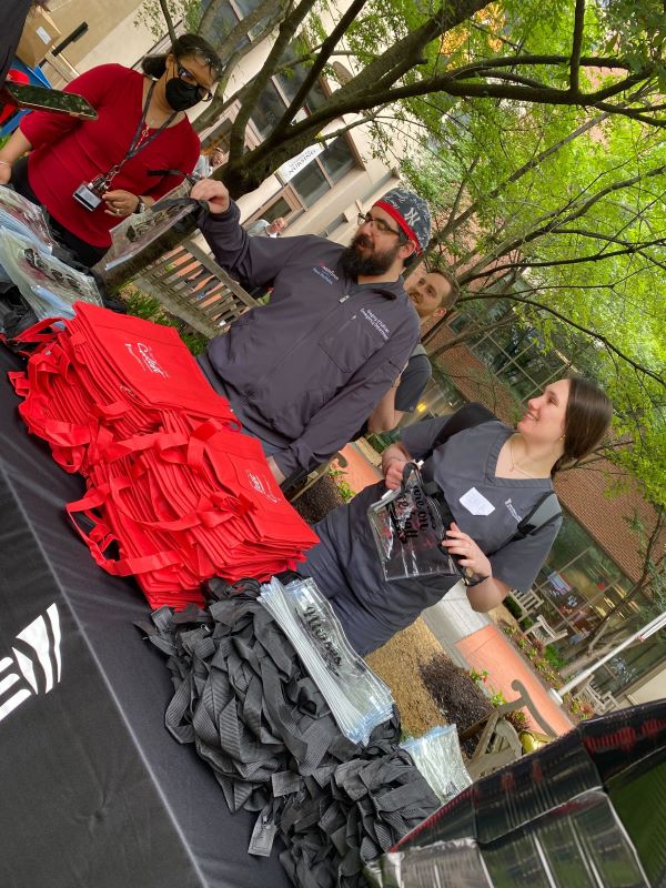 photo of swag bags on table with students picking them up