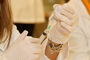 vial of medicine held by a resident's hands