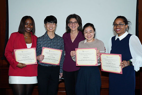 Udim Damachi, BPharm, MS; Yueh-Yi Chiang, BSPharm; Susan DosReis, Phd, BSPharm; Phuong Tran, BSPharm, MPH; and Nneka Okeke-Morgan, MHS facing the camera and smiling, holding their award certificates