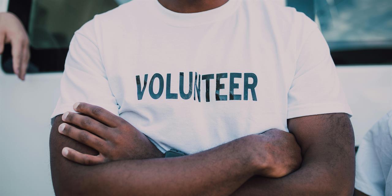 White T-shirt with black letters VOLUNTEER.