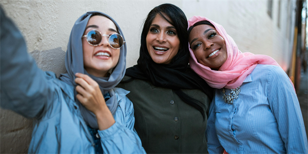 women taking photograph who are wearing a hijab