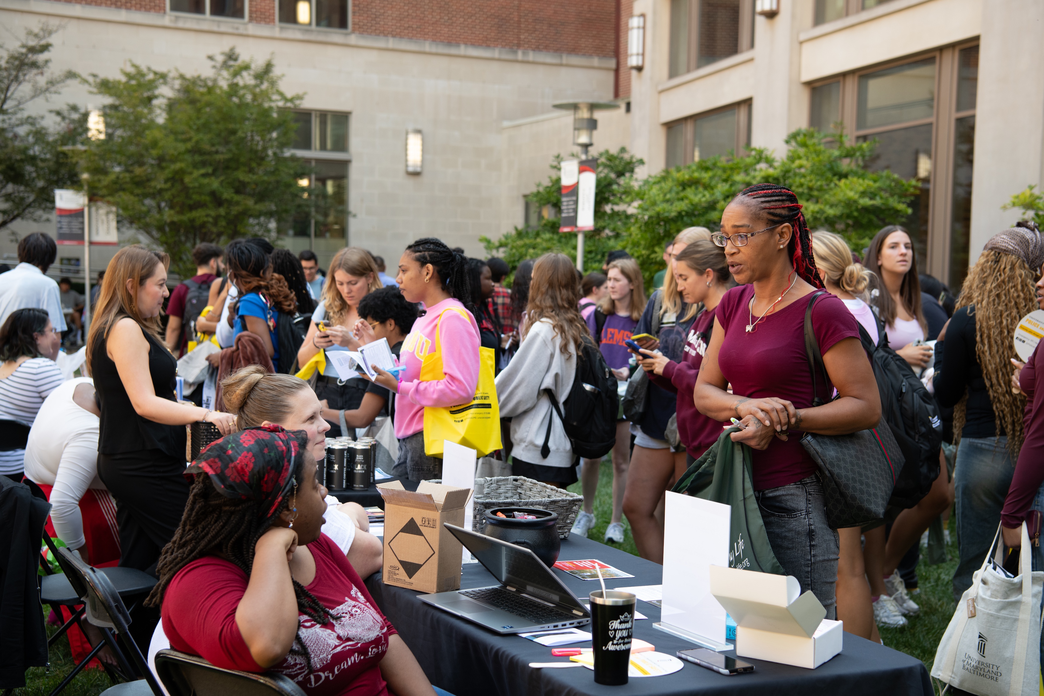 A student talks to someone manning a table at the Campus Involvement Fair in 2025.