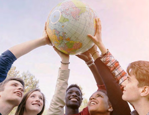 group of people holding up a globe