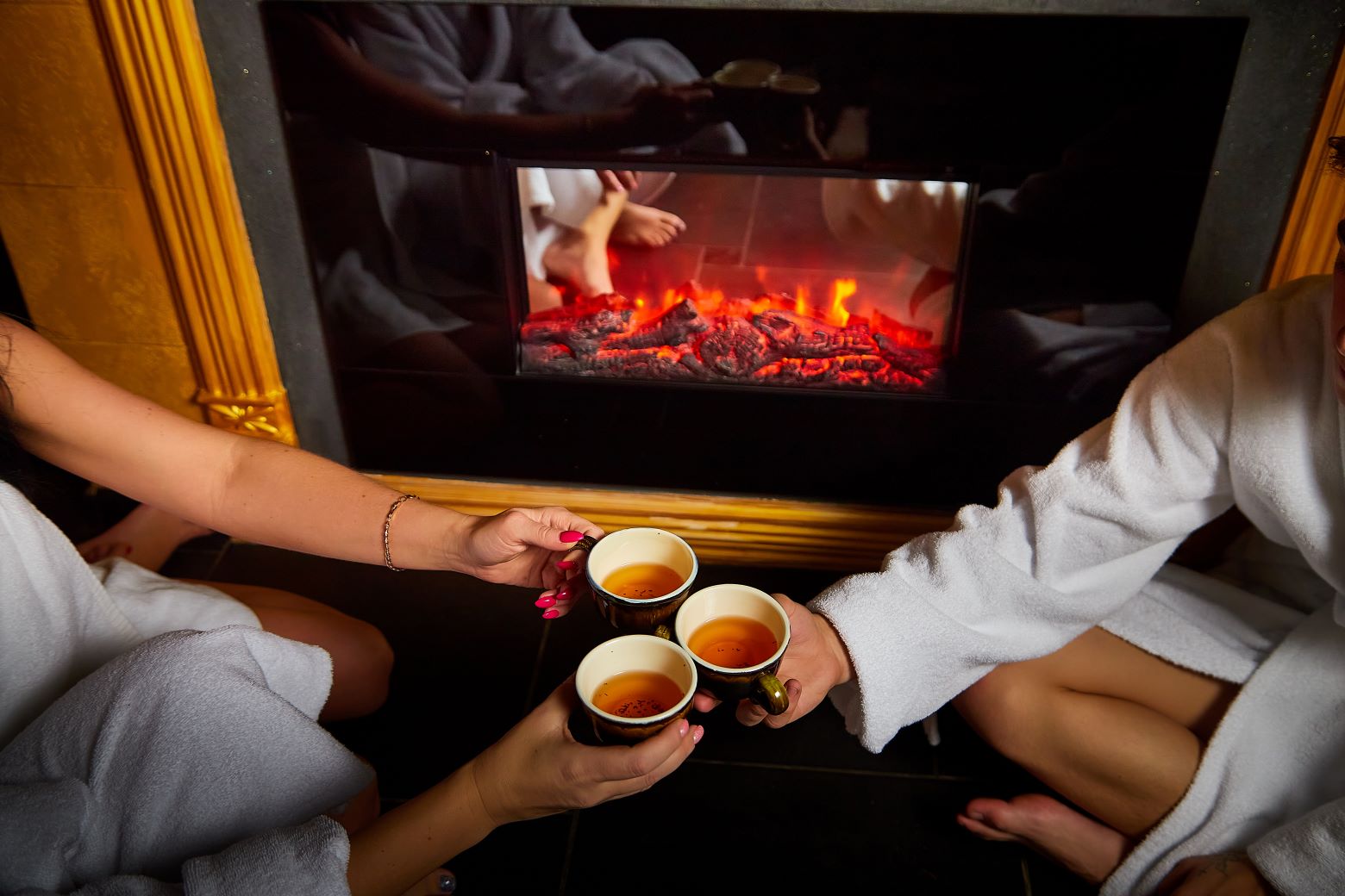 Three people clinking their coffee cups