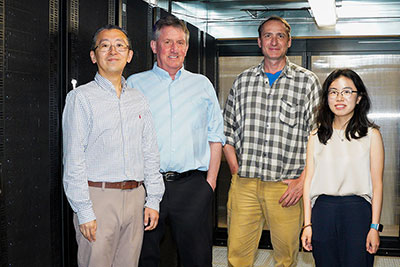 From left to right, Wenbo Yu, Alexander MacKerell, Ronald Kasl, and Yiling Nan stand in front of server racks in the CADD Center.