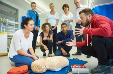 man teaching CPR to a group of people