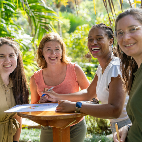 Four women stand at a table outside in Costa Rica