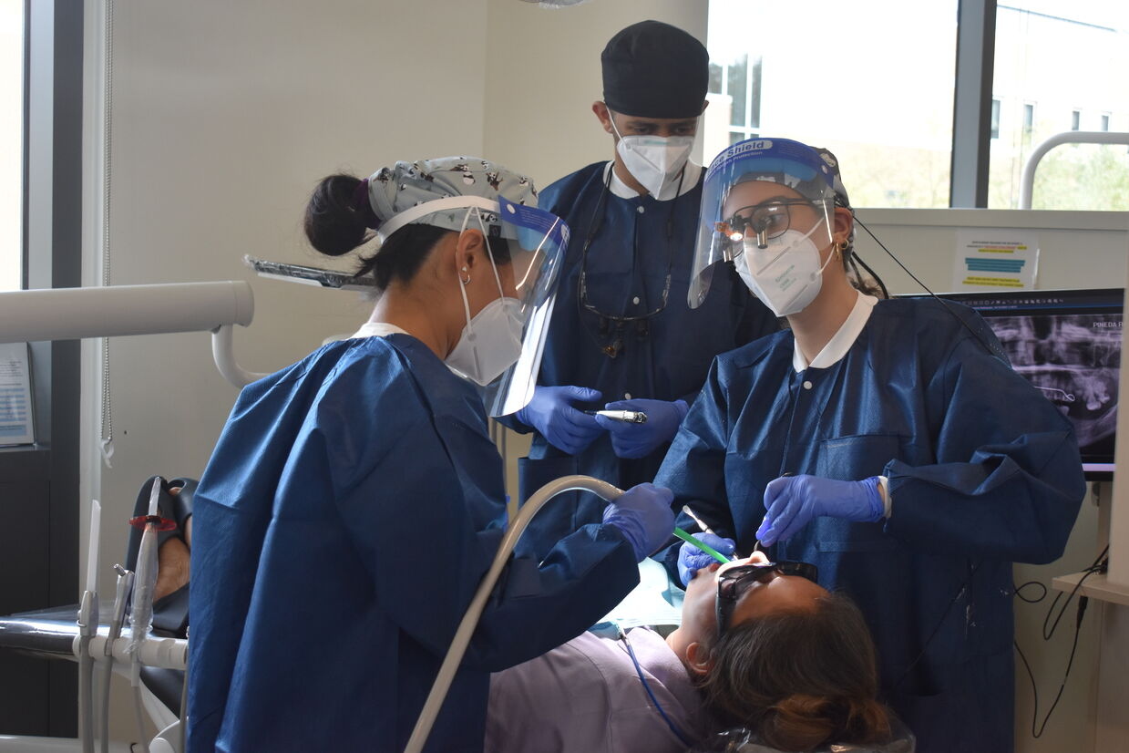 Photo of UMSOD dental students providing care to a patient at USG's Mission of Mercy event