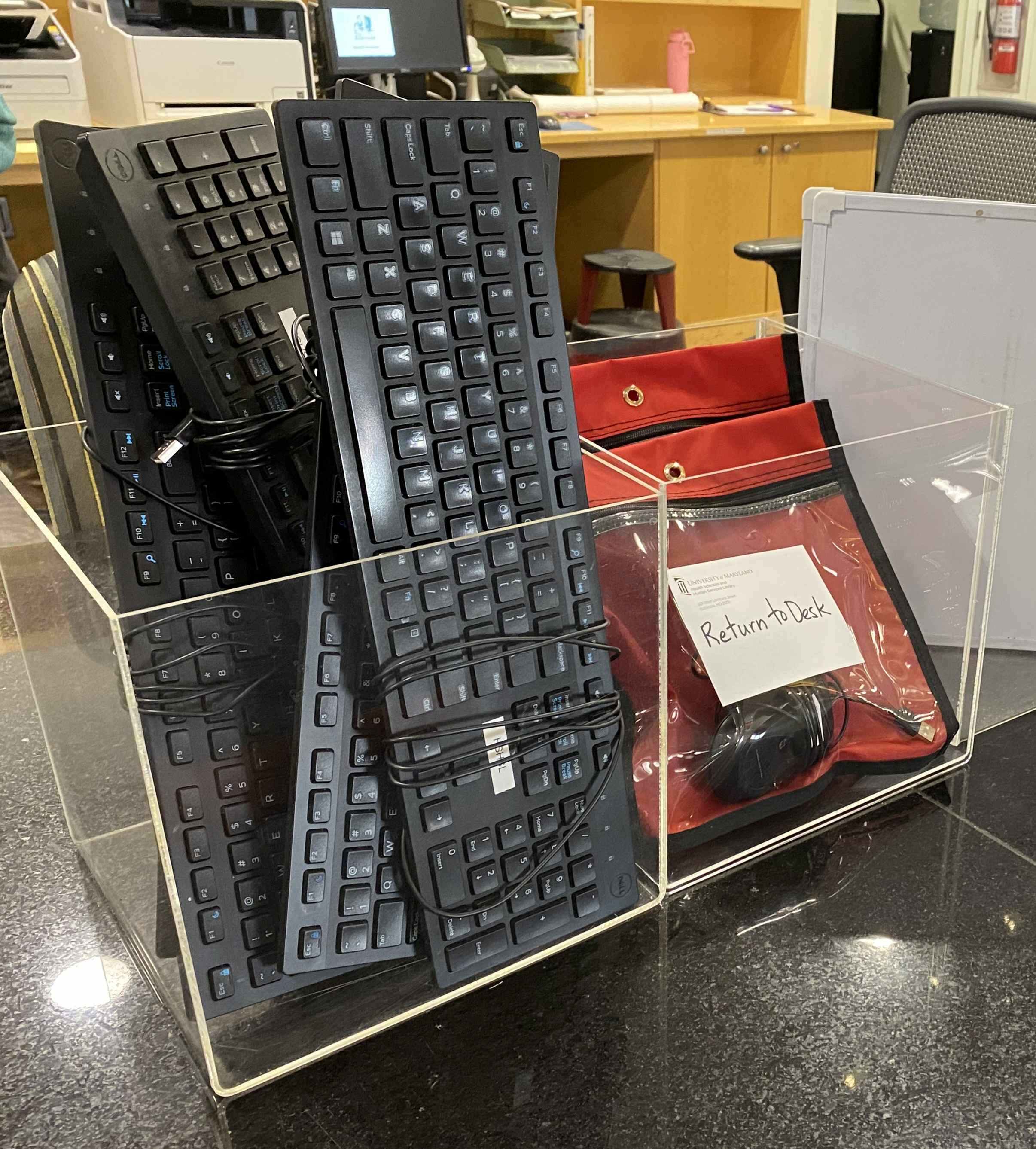 Clear bins of USB keyboards and mice available to use at the HSHSL.