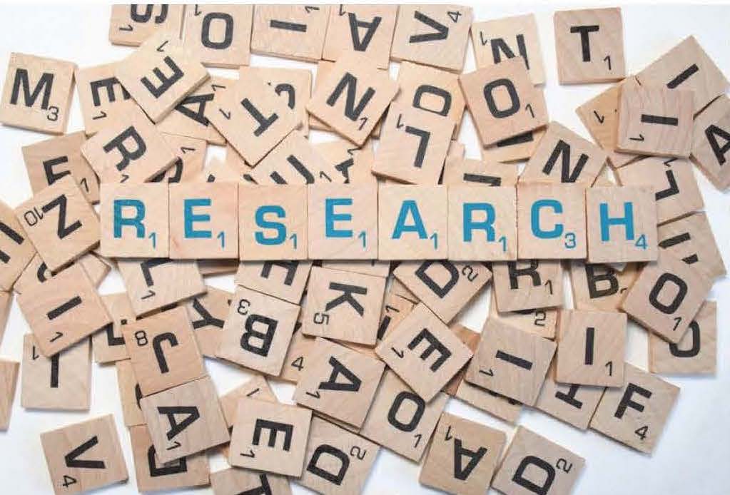 Graphic of tile pieces that spell out Research with other tile pieces piled in the background