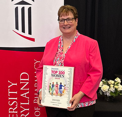Jill Morgan poses holding a Maryland’s Top 100 Women 2026 award plaque.