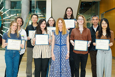 Research Day winners hold award certificates and pose with Dean Sarah L.J. Michel and Fengtian Xue. 