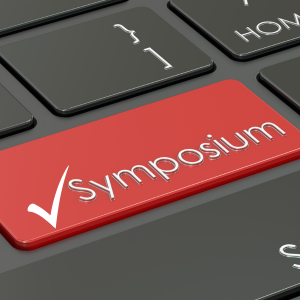 Keyboard with the word Symposium and white check mark