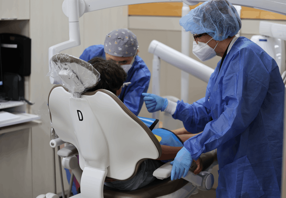 Photo of dental student and dental faculty performing an x-ray on a pediatric patient