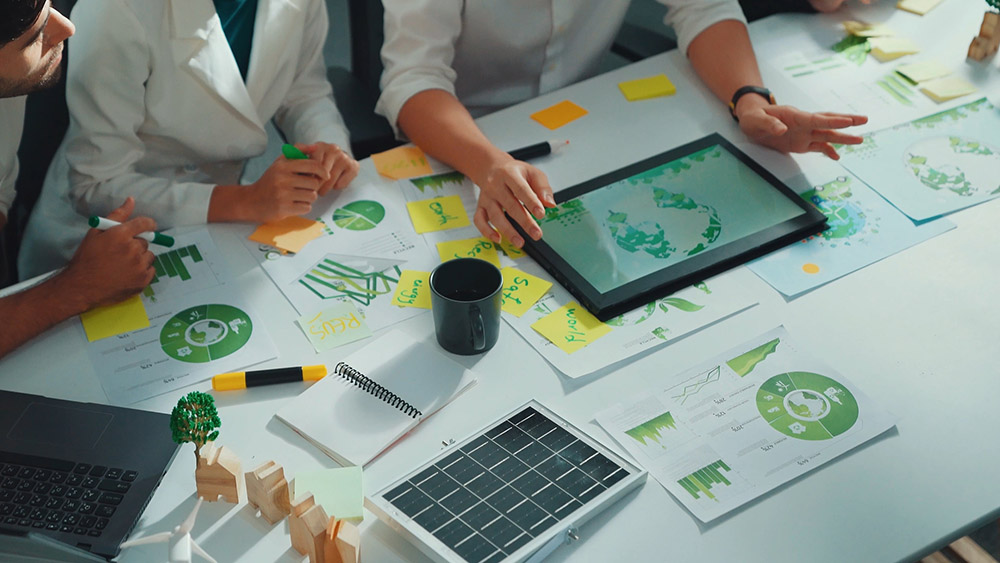 table filled with graphs and an ipad with data