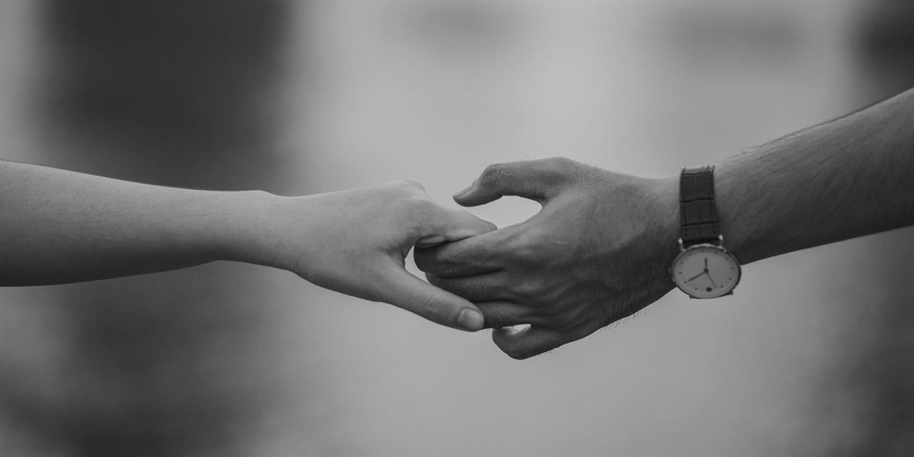 Two people holding hands