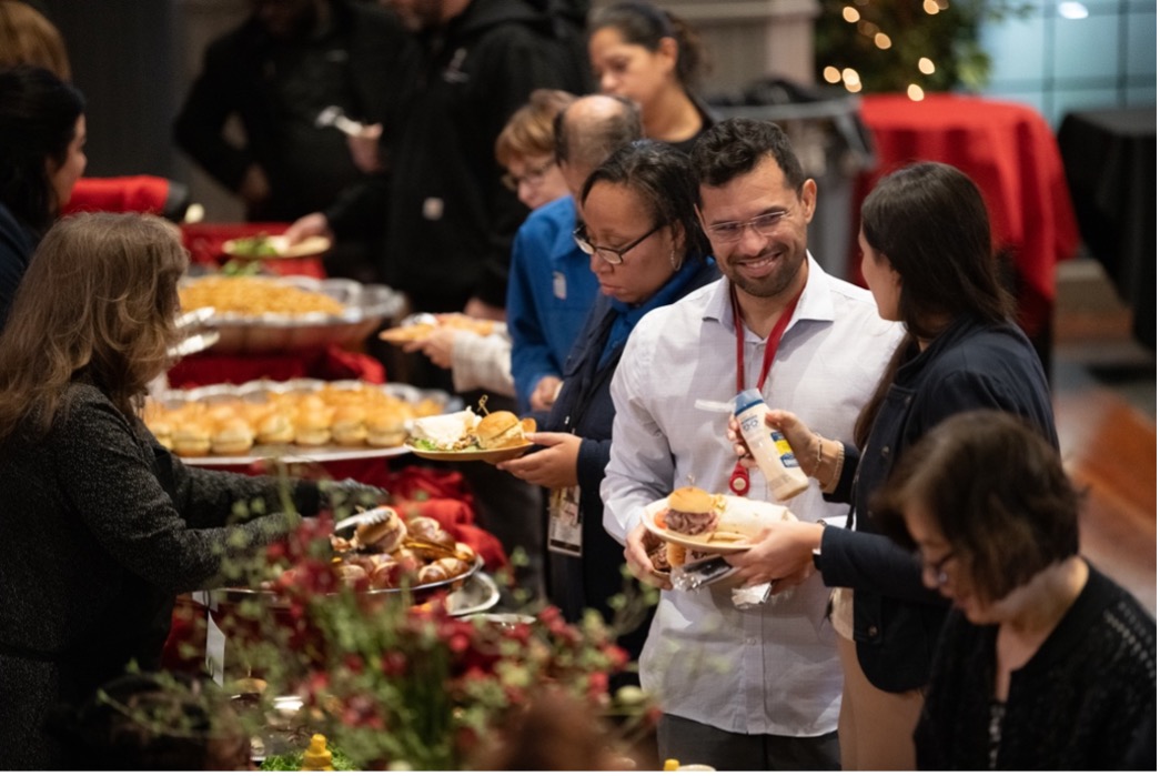 People enjoy food at the staff luncheon