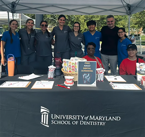 Photo of UMSOD volunteers gathering at table for group shot