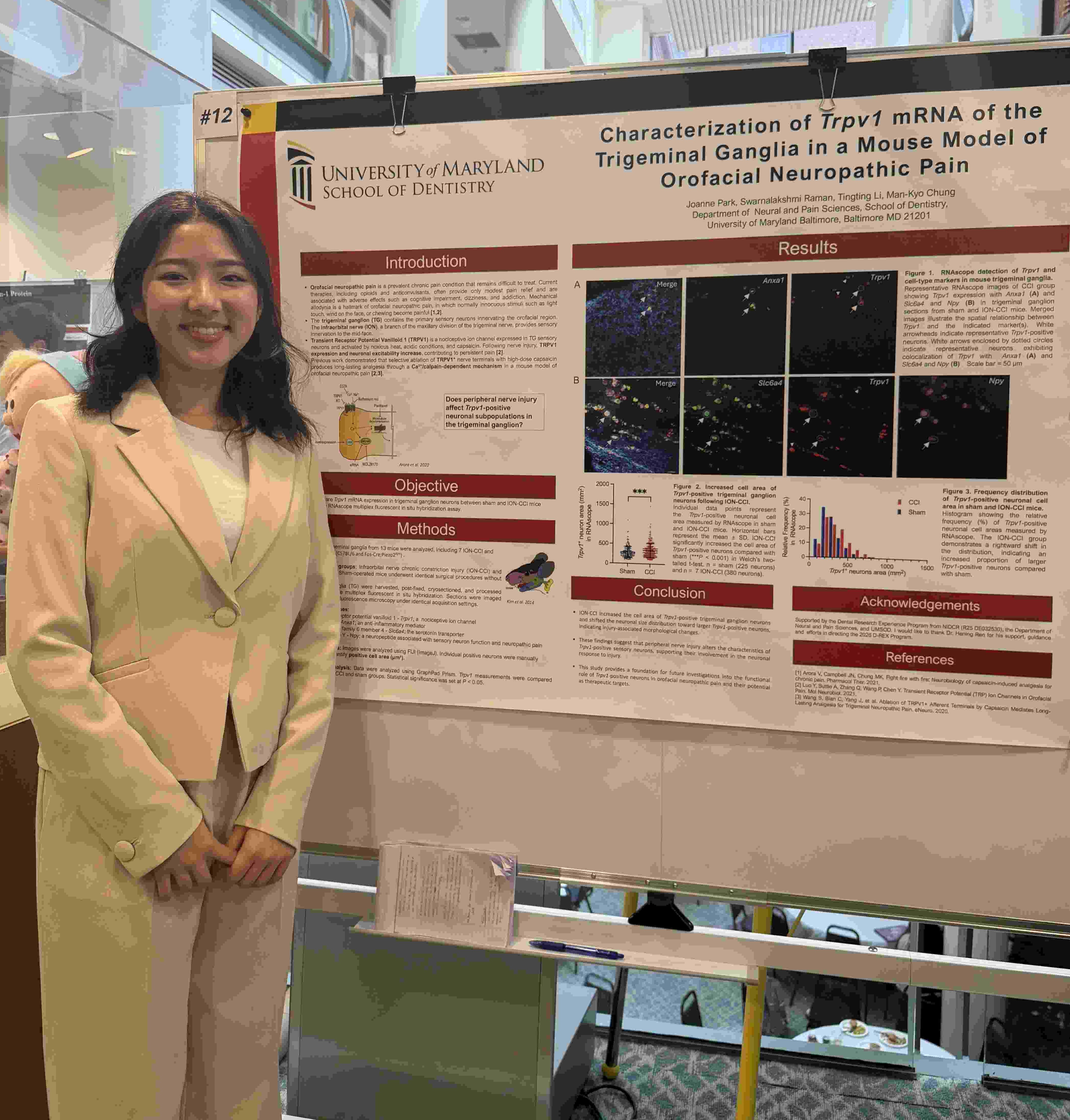 Photo of student standing by poster presentation for UMSOD Student Research Day