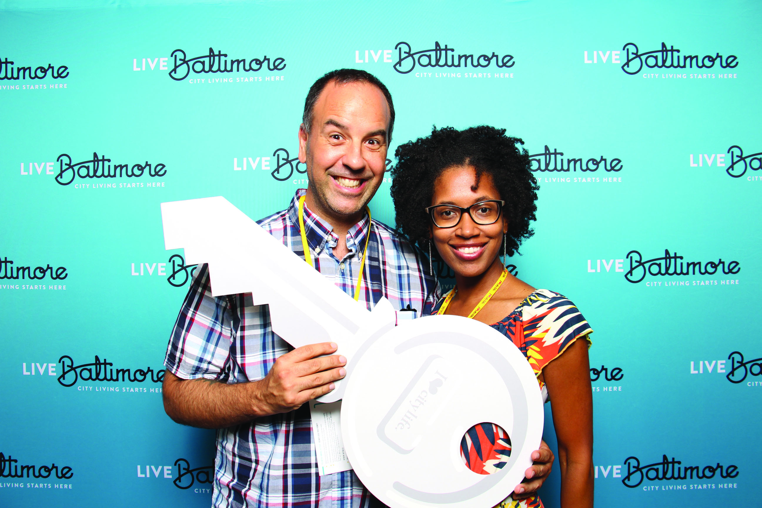 Couple Holding Large Key at Live Baltimore Event