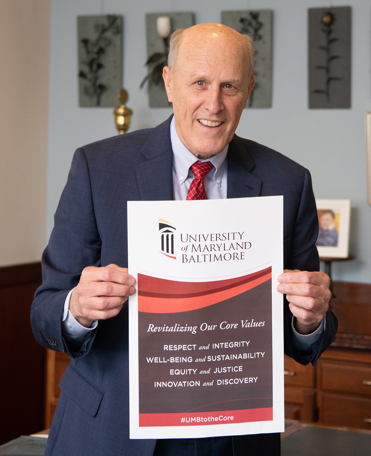 Dr. Jarrell holding sign with new core values